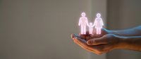 Protective hands holding glowing family icons representing care, insurance coverage, and security for loved ones in modern healthcare concept.