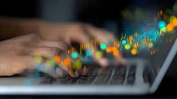 Trading chart analysis on laptop keyboard with colorful stock market data visualization and candlestick patterns showing financial market trends and statistics.
