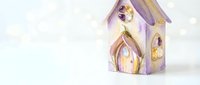 Whimsical purple and gold decorative birdhouse with glowing windows on soft bokeh background, suitable for holiday decor, seasonal marketing, and festive home design projects.