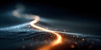 Illuminated winding road at night with glowing light trail and bokeh effect, creating atmospheric perspective for transportation themes.