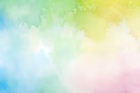 Soft pastel watercolor background with blended rainbow hues of blue, green, yellow and pink creating dreamy ethereal texture for artistic designs and wallpapers.
