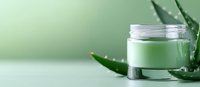 Luxurious green cosmetic cream jar with fresh aloe vera leaves on mint background, natural skincare and organic beauty product photography.