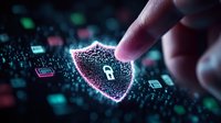 Hand touching glowing digital shield with lock icon on circuit board background representing cybersecurity protection and data privacy technology concepts.