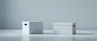 Modern minimalist white storage boxes with handles on clean neutral background for home organization and decluttering solutions.