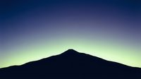 Mountain silhouette against twilight sky with gradient from purple to yellow-green, suitable for backgrounds, nature themes, and atmospheric design projects.