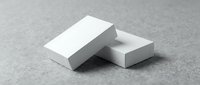 Two blank white business cards stacked on a gray textured surface, mockup template for branding and corporate identity design presentation.