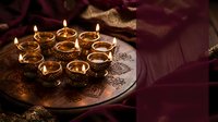 Traditional brass oil lamps arranged on ornate metal tray creating warm ambient lighting for Diwali festival celebration with decorative textiles.