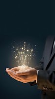 Businessman in dark suit holding glowing light particles and sparkling magic in cupped hands against dark background for innovation and success concepts.