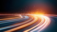 Colorful light trails curving along highway at night with glowing particles, representing speed, technology, and digital transformation in modern transportation.