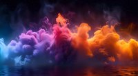 Vibrant colorful smoke clouds reflecting in water surface with blue, purple, red and orange hues creating dramatic atmospheric abstract background.