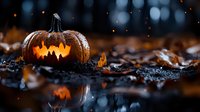 Glowing carved pumpkin with scary face on dark autumn ground with fallen leaves and water reflection. Mystical Halloween atmosphere with bokeh lights.