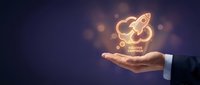Business hand holding glowing rocket icon symbolizing startup launch, innovation and entrepreneurship growth on dark background with bokeh lights.