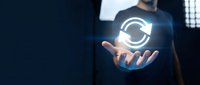 Man in dark shirt holding glowing refresh icon, symbolizing system update, data synchronization, and digital technology innovation for web and software applications.