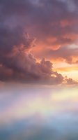Dramatic sunset sky with purple and orange clouds creating atmospheric mood for nature backgrounds and weather concepts.