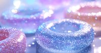 Magical glitter bowls with sparkling pink and blue colors against dreamy bokeh background create enchanting festive atmosphere for party decoration and celebration design.