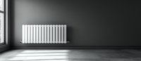 White modern heating radiator on dark gray wall in empty minimalist room with natural window light casting dramatic shadows on floor.