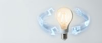 Glowing light bulb surrounded by floating digital icons representing innovation, technology and creative business solutions for modern corporate presentations.