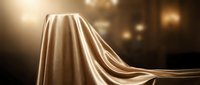 Flowing golden silk fabric with dramatic light rays and bokeh background, suitable for luxury, elegance, and premium product presentations.
