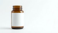 Amber glass medicine bottle with blank white label isolated on white background for pharmaceutical packaging and supplement branding mockup.