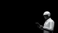 African American male chef in white uniform and hat using tablet device on black background for culinary technology and restaurant management concepts.