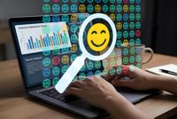 Customer satisfaction analysis concept with hands typing on laptop displaying survey analytics dashboard and magnifying glass highlighting happy emoji.