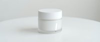 White cosmetic jar with lid on clean background for skincare product packaging and beauty brand marketing materials.