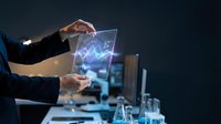 Businessman holding holographic tablet displaying digital analytics chart with glowing data visualization for technology and business solutions.