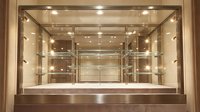 Empty luxury glass display case with LED lighting and multiple shelves for retail merchandise presentation in upscale store interior.