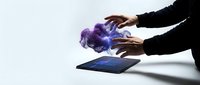 Hands hovering over tablet with magical purple and blue energy effects emerging from screen, digital technology concept for futuristic interface design.