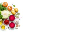 Fresh vegetables and cooking ingredients arranged on white background with copy space for culinary designs and recipe layouts.
