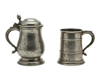 Antique pewter tankards with hinged lid and handle, isolated on white background, suitable for vintage home decor, antique collecting, and historical design projects.