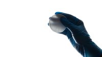 Medical professional wearing blue nitrile gloves holding petri dish for laboratory research and scientific analysis on white background.