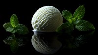 Single scoop of vanilla ice cream with fresh green mint leaves on dark reflective surface against black background, dramatic food photography.