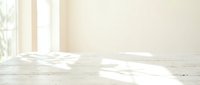 Empty bright room interior with white wooden floor and natural sunlight streaming through windows creating soft shadows and warm atmosphere.