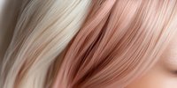 Close-up macro shot of blonde and rose gold hair strands creating soft gradient texture background pattern with selective focus and blur effect.