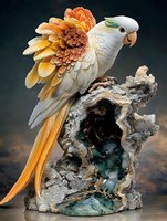 White parrot with orange-gold wings perched on crystalline geode formation against dark background, wings spread in detailed sculptural arrangement showing intricate feather detail.