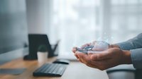 Businessman hands holding digital global network connection with technology icons in modern office workspace for international business communication.