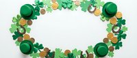 St Patrick's Day festive oval frame with green shamrocks, gold coins and leprechaun hats on white background for Irish holiday celebration designs.