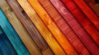 Colorful wooden planks arranged diagonally showcasing natural grain patterns from turquoise blue to deep red, perfect for interior design, architecture, and construction backgrounds.