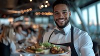 Young African American male waiter in bow tie and apron carries plates with gourmet dishes, smiling warmly in upscale restaurant with bokeh lights and evening ambiance.