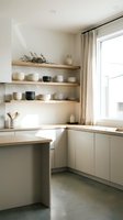 Minimalist kitchen interior with open wooden shelves displaying ceramic dishware, neutral cabinetry, natural light from window, and concrete flooring for modern home design and interior decoration projects.