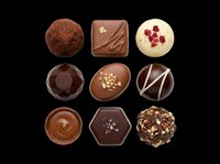 Nine assorted gourmet chocolate pralines and truffles, isolated on transparent background, ready for confectionery menus, stickers, T-shirt designs, and print on demand.