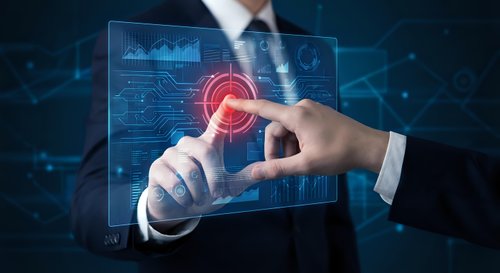 Businessman touching futuristic holographic interface with glowing red target button and digital data analytics dashboard for business technology solutions.