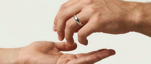 Caring hands reaching toward each other in gentle gesture of support and connection on clean white background for healthcare design.