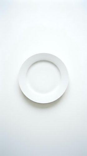 Empty white ceramic plate on clean white background isolated for kitchen and dining design projects.