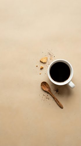Overhead view of steaming black coffee in white ceramic mug with wooden spoon and scattered coffee beans on neutral beige background, ideal for cafe and beverage marketing.