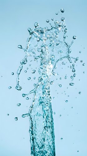 Clear water splash with droplets and bubbles rising upward against light blue background for refreshment and hydration concepts.