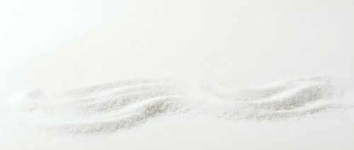 Fine white sand texture with gentle wave patterns across neutral background, suitable for spa, wellness, and minimalist design projects.
