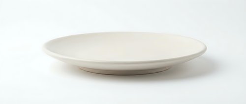Empty white ceramic plate isolated on white background for food presentation and kitchen design projects.