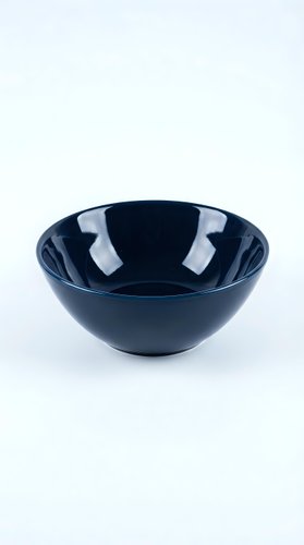 Dark navy blue glossy ceramic bowl isolated on white background, showcasing sleek modern kitchenware design for food styling and product photography.
